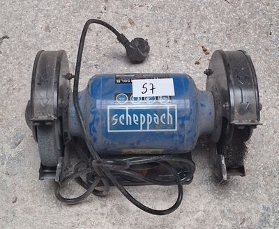 une pompe à eau bleue et noire posée par terre