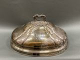 a silver plate with a lid that has a bird on it