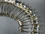 a lot of spoons arranged in a circle on a table