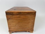 an old wooden box sitting on top of a white surface