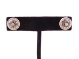 a close up of a pair of earrings on a black stand