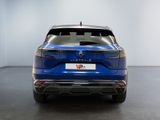 the rear end of a blue car in a white room
