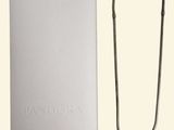 an image of a necklace and a box on a white surface