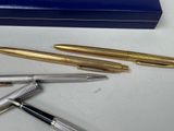 a few pens and a box on a table