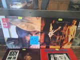 three records on a table with a picture of a man