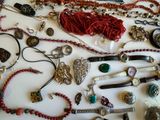 many different types of necklaces and bracelets on the table