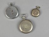 two silver and gold pocket watches and a silver and gold pocket watch