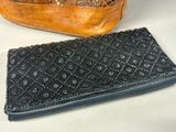 two purses that are sitting next to each other on a table