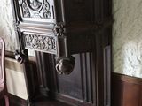 a tall wooden cabinet in the corner of a room