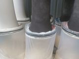 four white vases that are sitting on top of each other