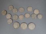 several silver coins are arranged in a circle on a gray surface