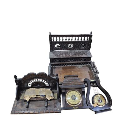 a wooden bed with a clock and other items on it