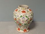 a vase that is sitting on a table with a wall in the background