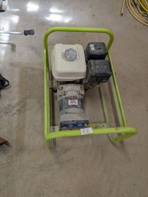 a small green cart with a water pump on the floor