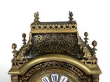 a gold clock with black and white roman numerals on it