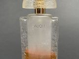 a close up of a bottle of perfume on a table