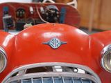 a close up of a red toy car with its hood up