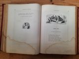 a book open on a table with a picture of a man and a woman