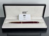 a close up of a pen in a box on a table