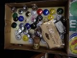 a box full of assorted bottle caps and magnets