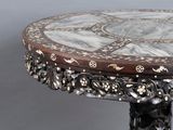 a table with a marble top and a wooden base