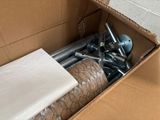 a cardboard box with a bunch of screws in it