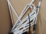 a cardboard box with a bunch of white pipes inside of it