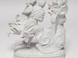 a figurine of a man and a woman riding on a horse