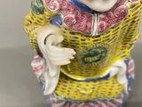 a figurine of a man with a hat on his head