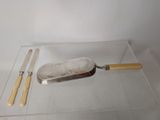 a glass display case with a knife and a knife rest on it