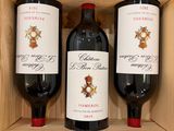 three bottles of wine sitting in a wooden box