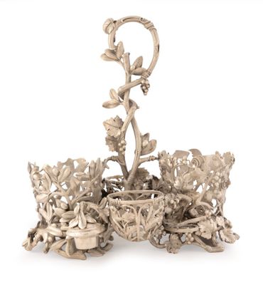 a silver candle holder with flowers and leaves on it