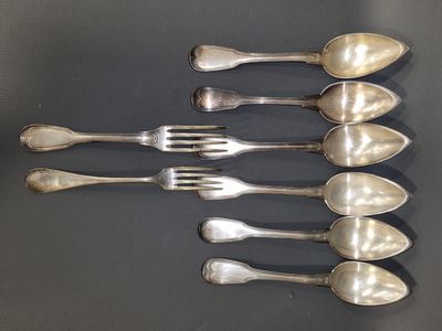 five spoons and a fork on a table