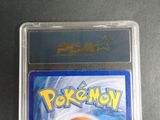 the pokemon card is in the plastic case on the table