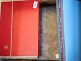 a red book sitting on top of a blue book case
