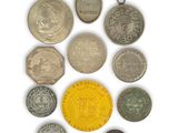 an image of a collection of coins and tokens on a white surface