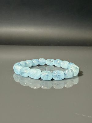 a bracelet made of blue glass beads on a table