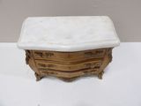 an antique marble top chest of drawers on display on a table