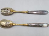 two spoons that are sitting next to each other on a table