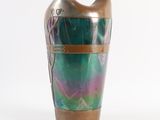 a vase that is sitting on a white surface