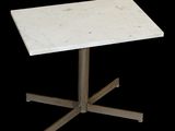 a white marble table with a metal base on a black background