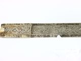 an old silver metal object with a decorative design on it