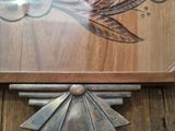 a wooden table with a clock on it and a person standing in front of it