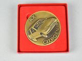 an image of a gold coin with a car on it in a red box