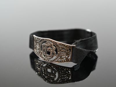 a close up of a silver buckle on a black belt