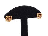 an image of a pair of earrings on a black stand