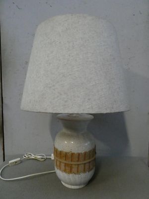 une lampe posée sur une table à côté d'un mur
