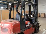a red forklift truck parked in a warehouse