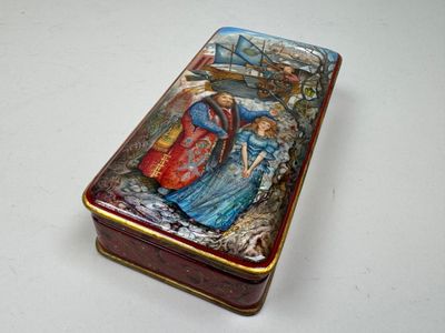 a small box with a painting on it on a table
