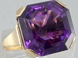 an image of a ring with a large purple stone in it
